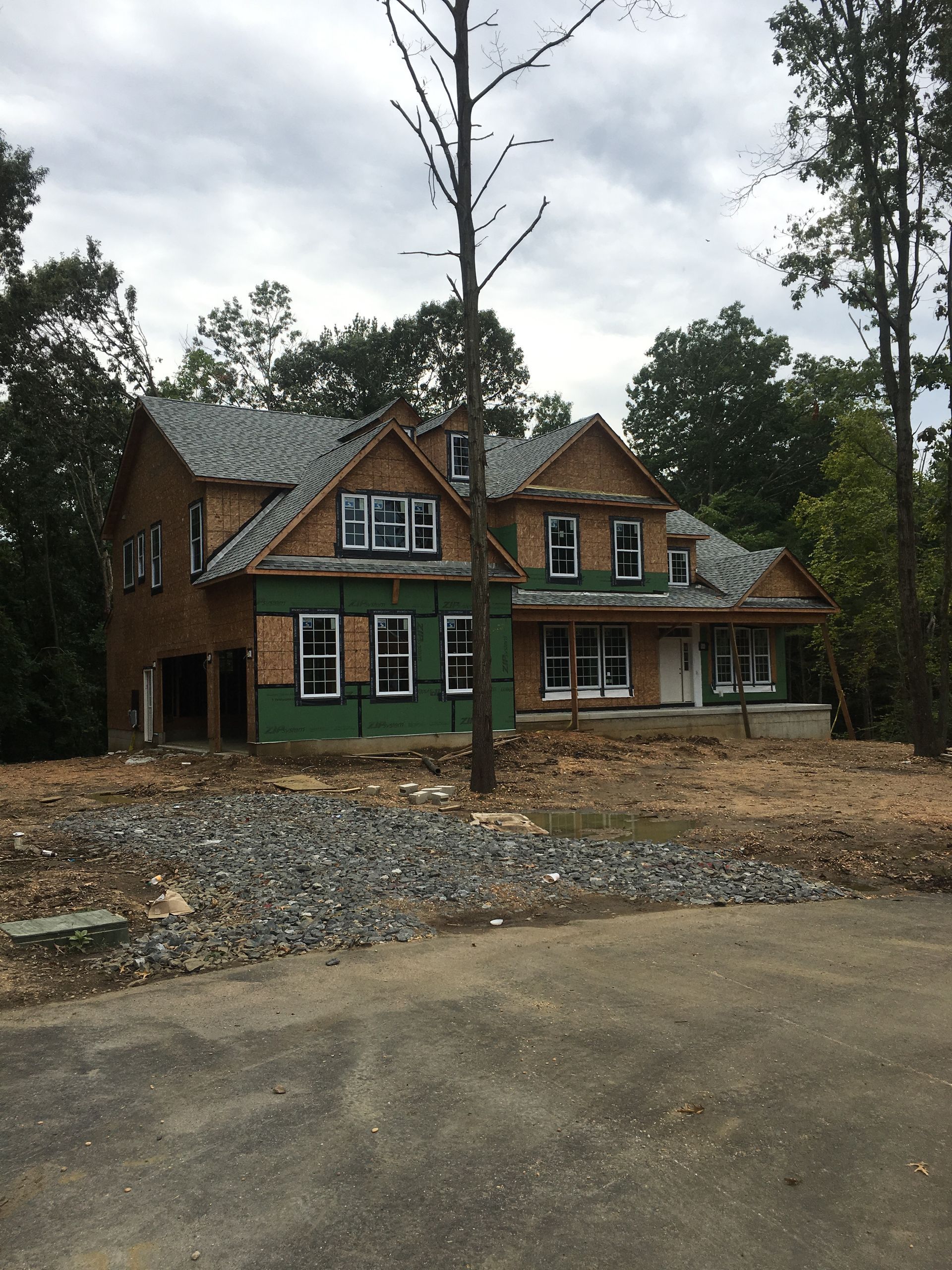 A house that is being built with a lot of windows