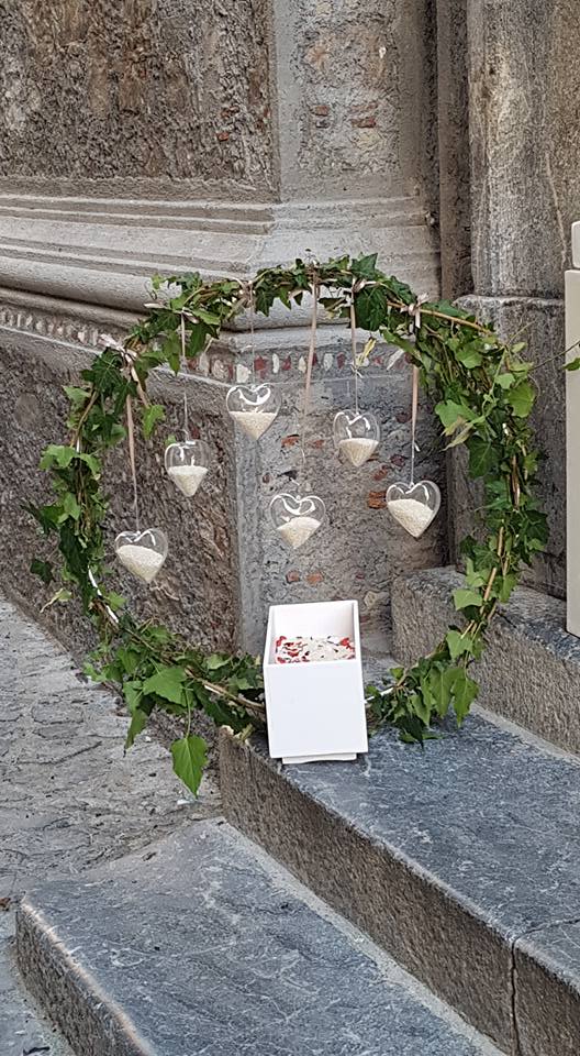 corona di foglie e bomboniere a forma di cuore