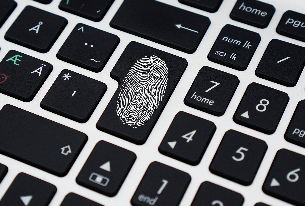 Image of a keyboard and a fingerprint indicating cybersecurity