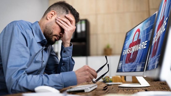 Image of a person feeling worried about their computer being infected with ransomware