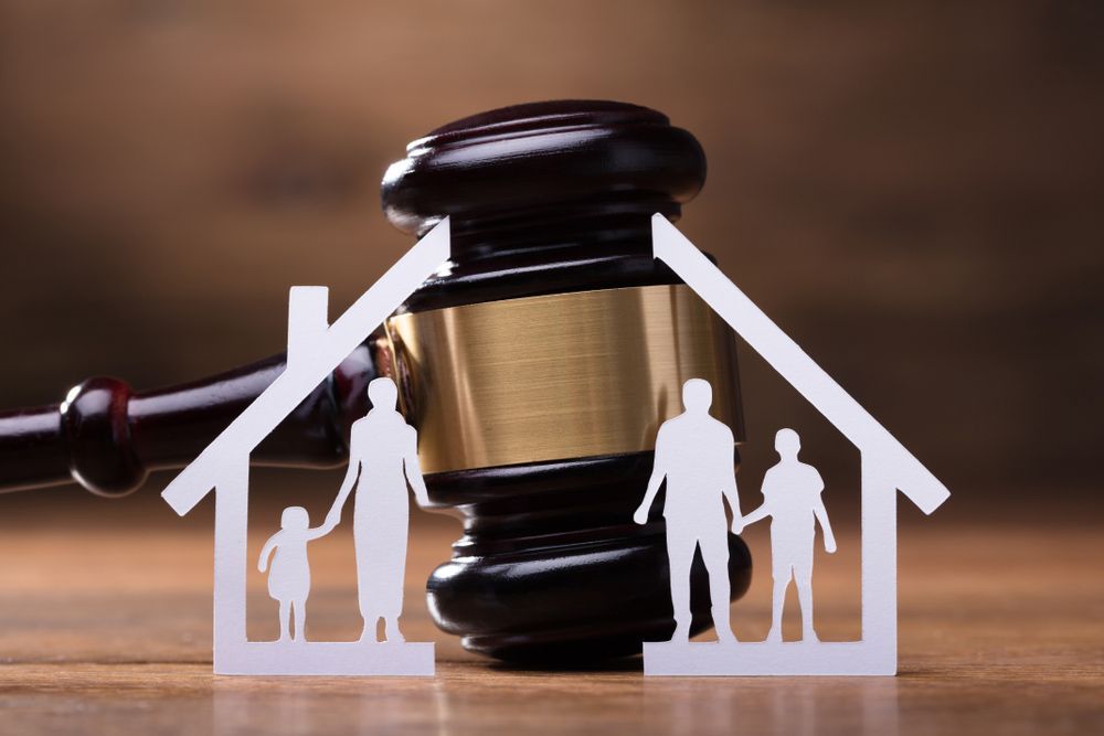 White Family Paper Cut Out In Front Of Judge Gavel — Family Law Solicitors in Muswellbrook NSW