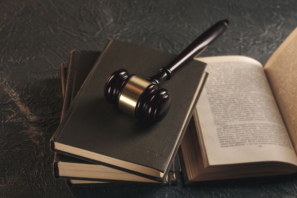 Open law book with a wooden judges gavel on table — Commercial Law Solicitors in Muswellbrook NSW