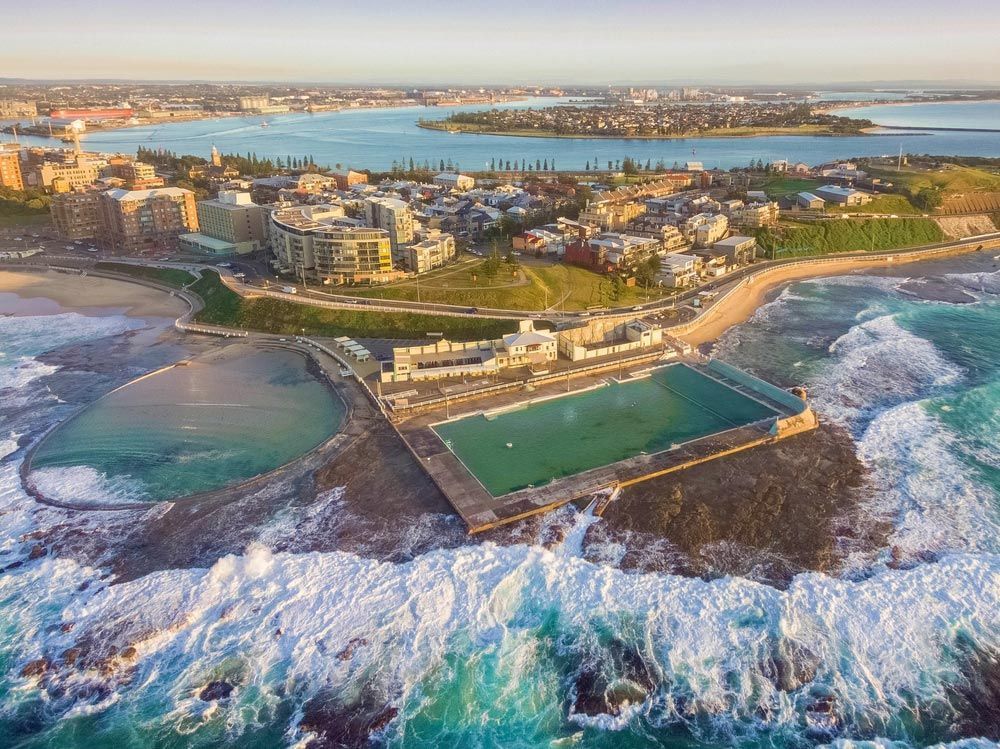 Aerial Shot Of Sun Rising Over The Ocean — Local Solicitors in Newcastle, NSW