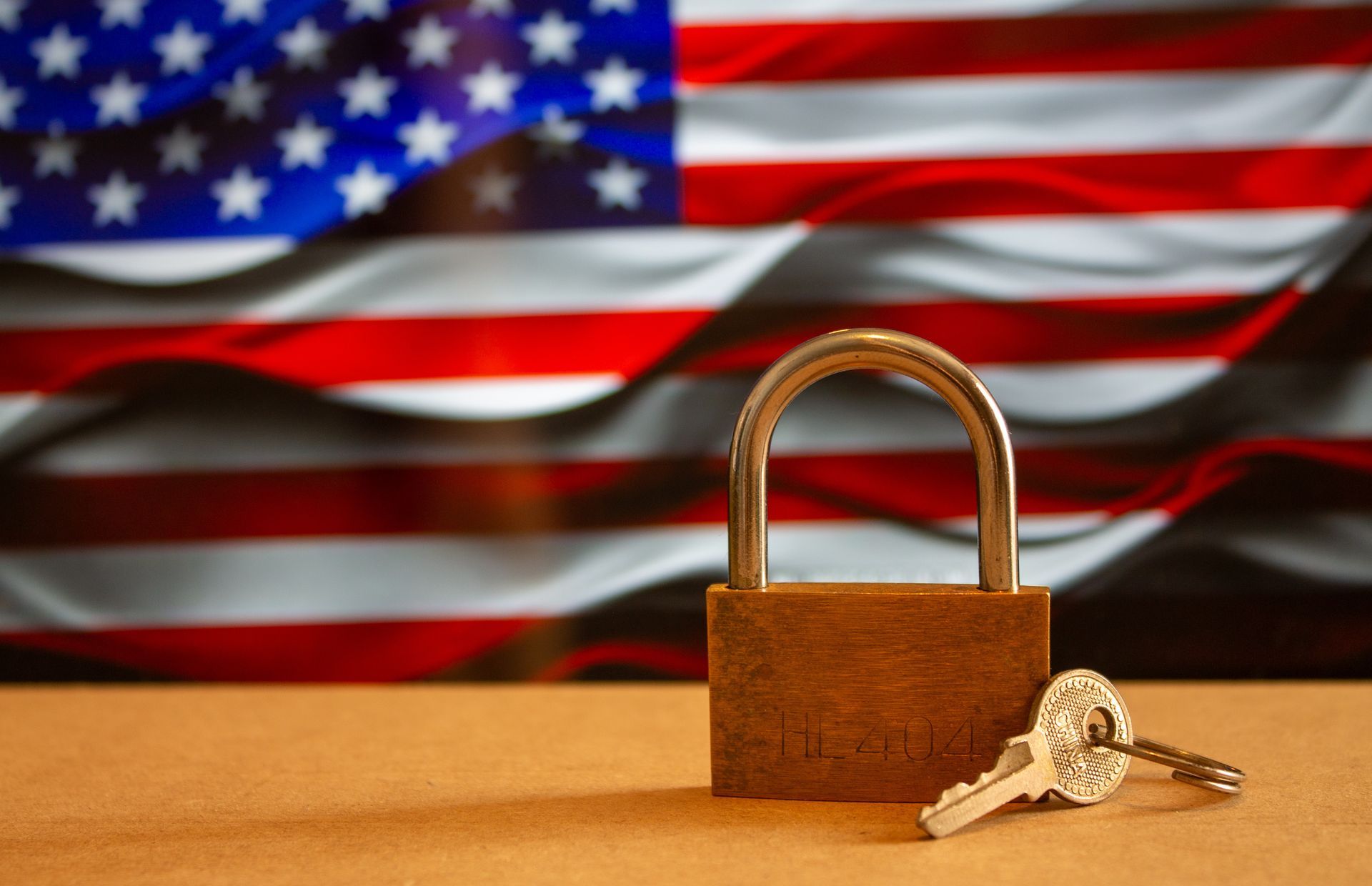 Padlock and keys in front of the American flag.