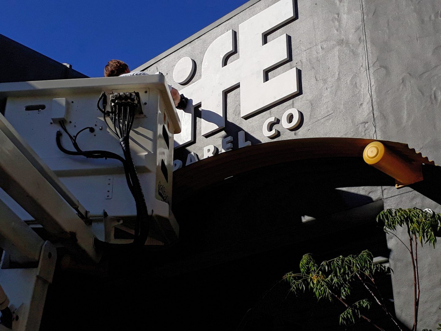 Man Installing 3D Logo — DNA Signs in Burleigh Heads, QLD