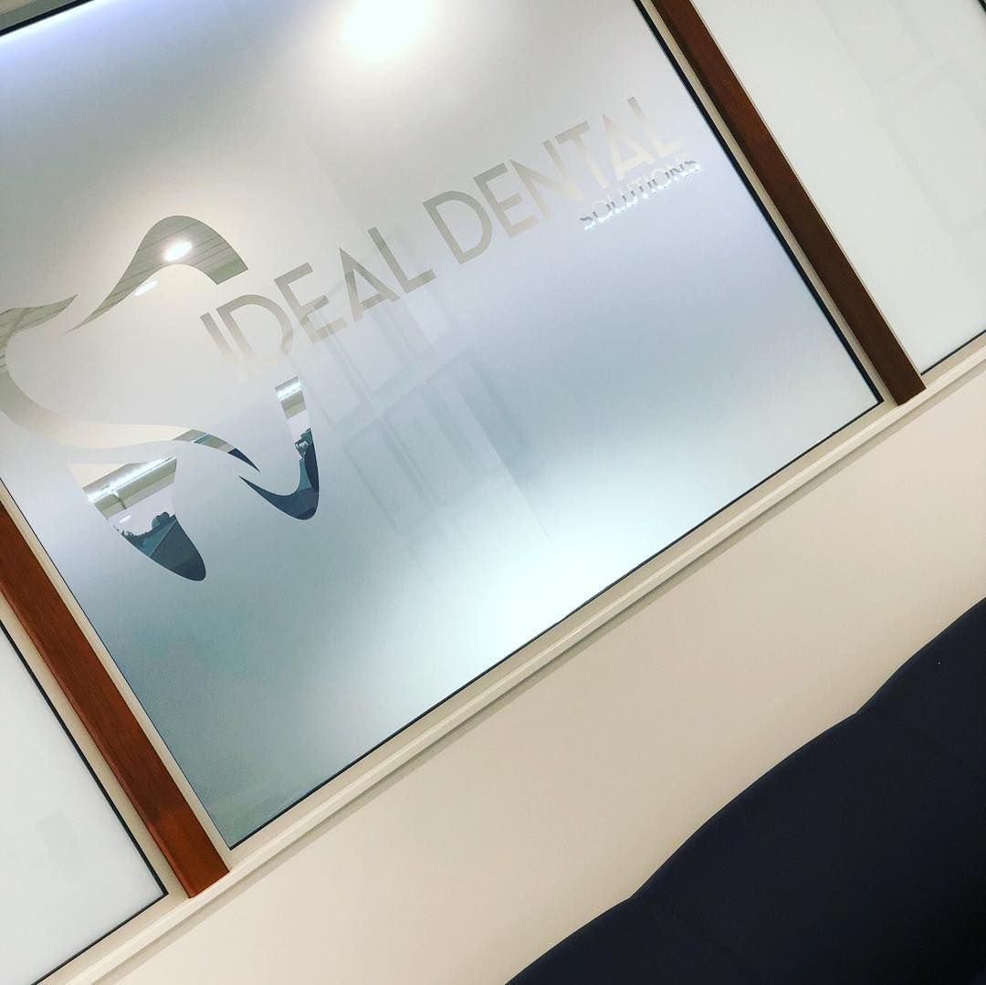 A Window with Ideal Dental Written on It — DNA Signs in Burleigh Heads, QLD