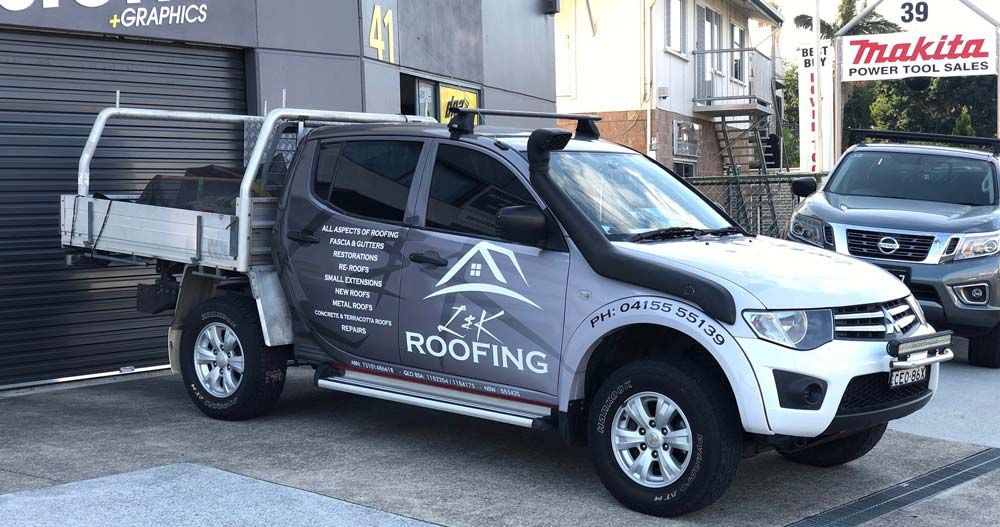 L & K Roofing Signage On A Car