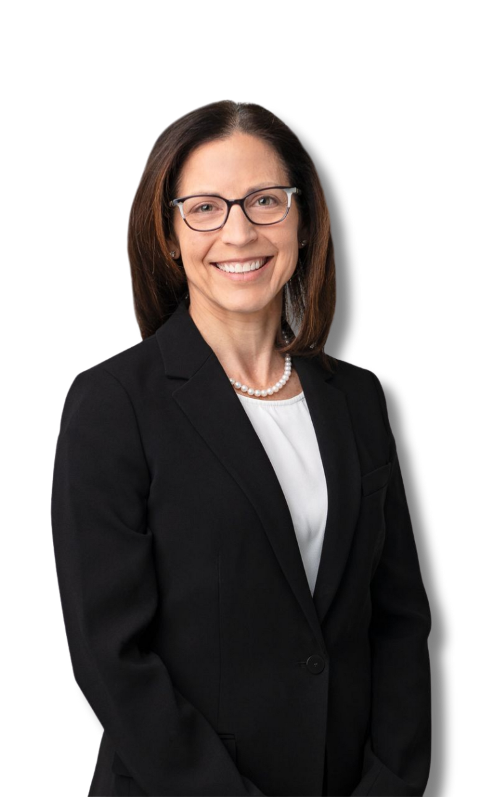 Woman in glasses and a black suit smiles, posing against a white backdrop.