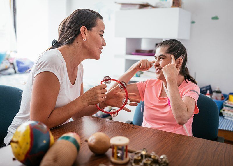 Guardian Playing Tambourine with a Woman — Lexington, KY — Kentucky Guardianship Association