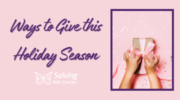 A child is holding a pink gift box with a bow.