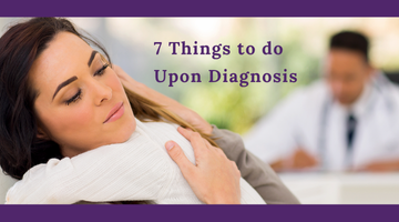 A woman is hugging another woman in front of a doctor.