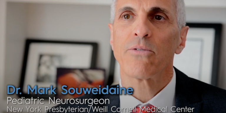A close up of a man in a suit and tie with the name mark souweidaine on the bottom