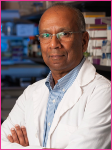 A man in a lab coat with his arms crossed