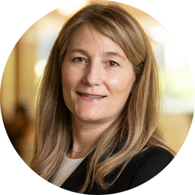 A woman with long blonde hair is smiling in a circle.