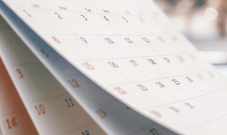 A close up of a calendar showing the days of the month