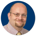 A man with glasses and a beard is smiling in a blue circle.