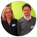 A man and a woman are standing next to each other in a circle.