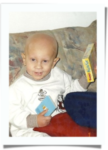 A young boy sitting on a couch reading a book
