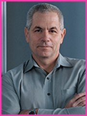 A man in a grey shirt with his arms crossed