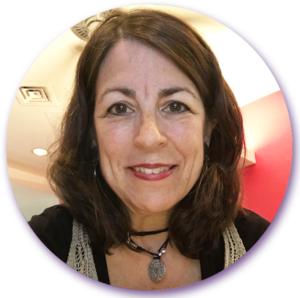 A woman wearing a choker necklace smiles for the camera