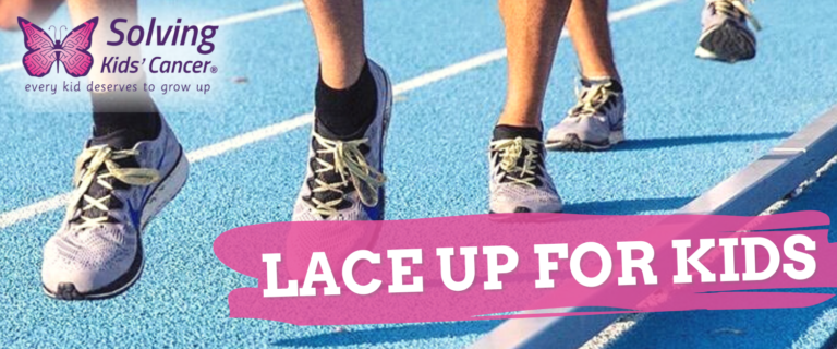 A person is standing on a track with a sign that says lace up for kids