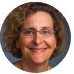 A woman wearing glasses is smiling in a circle.