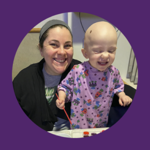 A woman and a baby are smiling in a purple circle