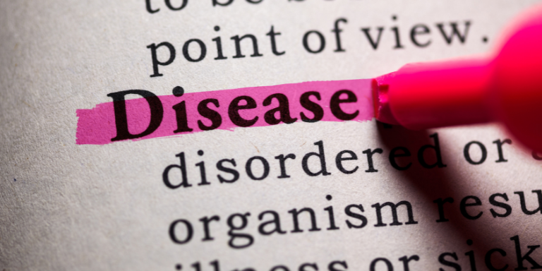 A pink marker is highlighting the word disease in a dictionary