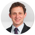 A man in a suit and tie is smiling in a circle.
