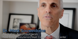 A man in a suit and tie is named dr. mark souweidaine