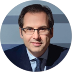 A man wearing glasses and a suit and tie is in a circle.