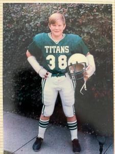 A young boy dressed as a football player for the titans