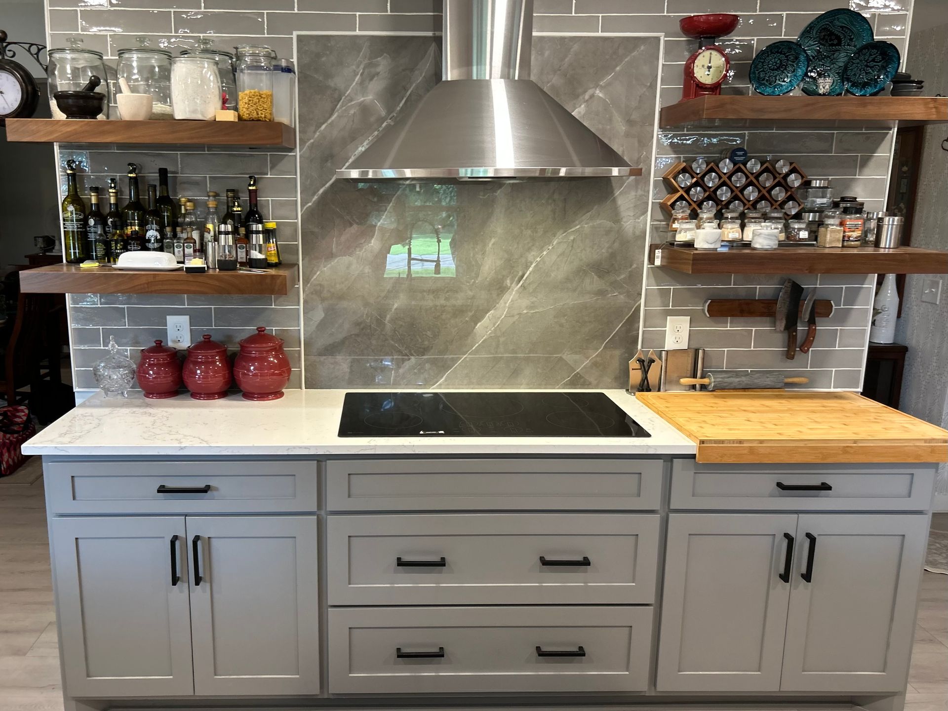 A kitchen with a stove top oven and a hood.