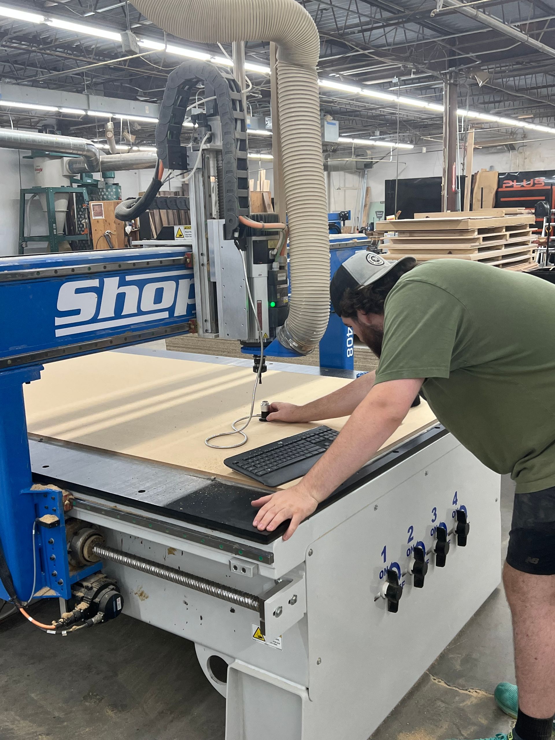 A man is working on a machine that says shop on it