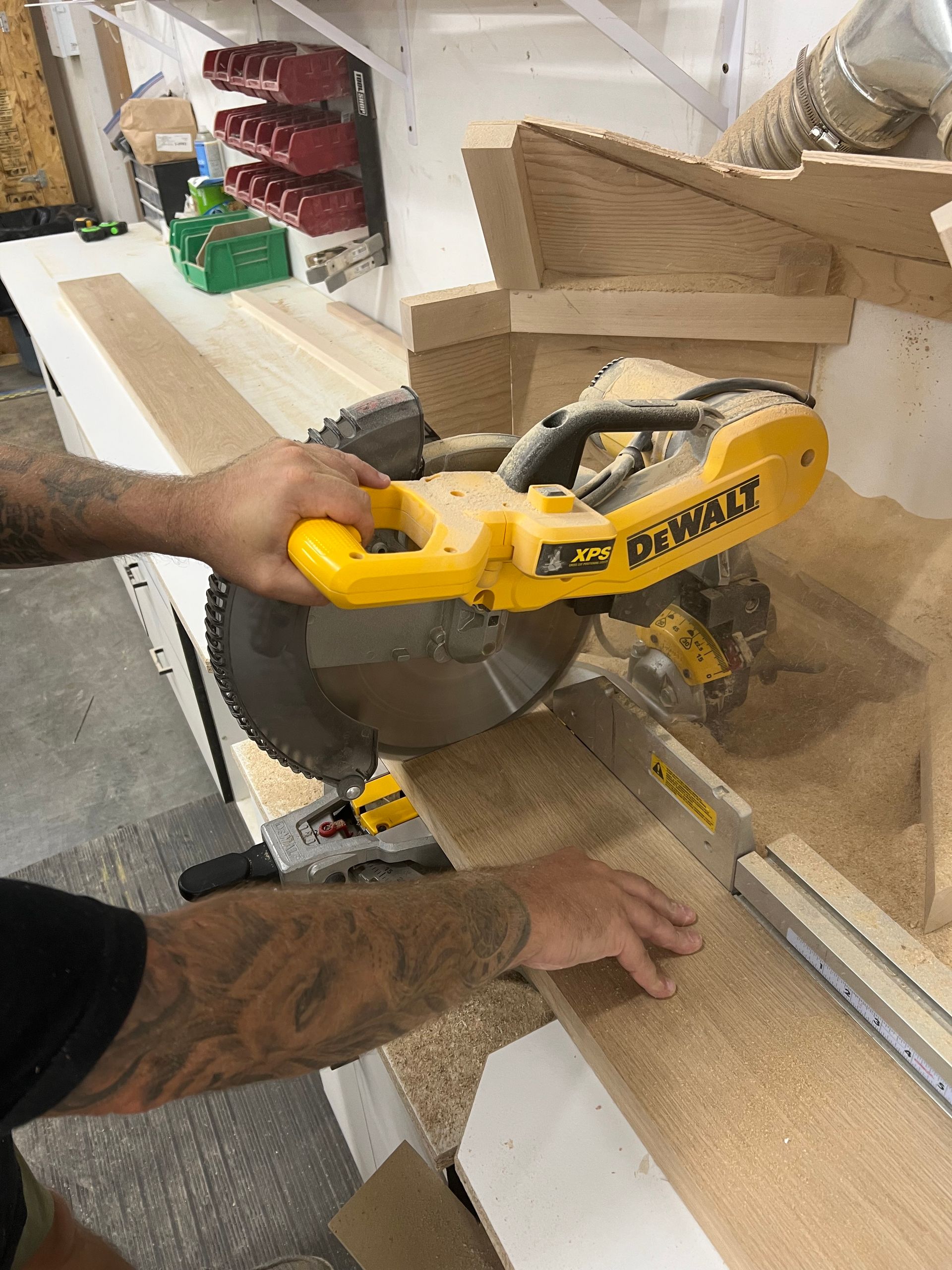 A man is using a dewalt circular saw to cut a piece of wood.