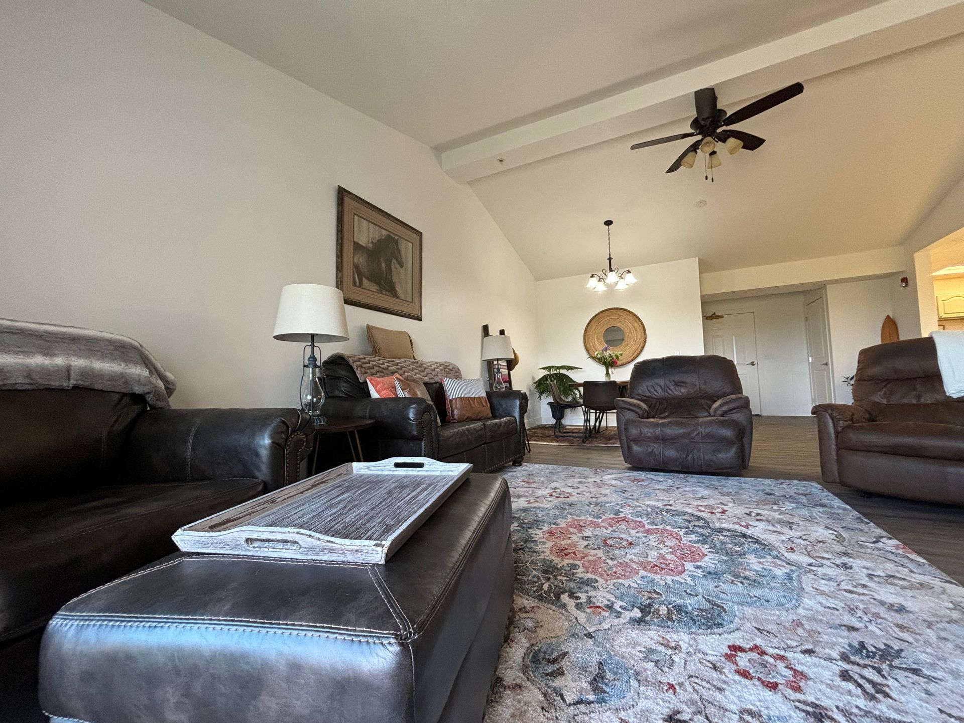 A living room filled with furniture and a ceiling fan.