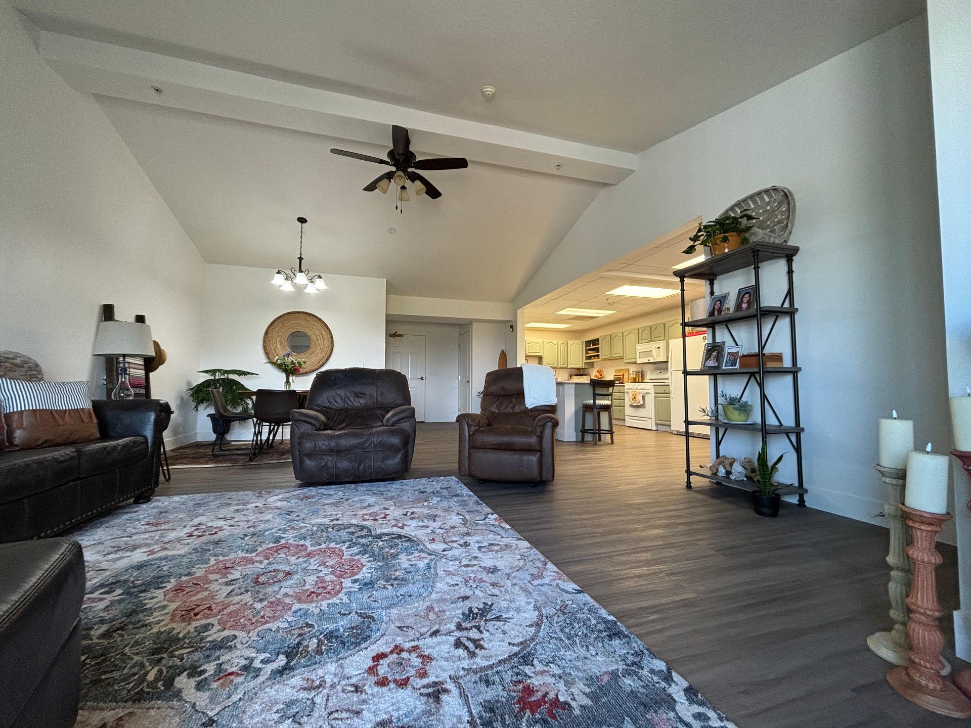 A living room filled with furniture and a ceiling fan.