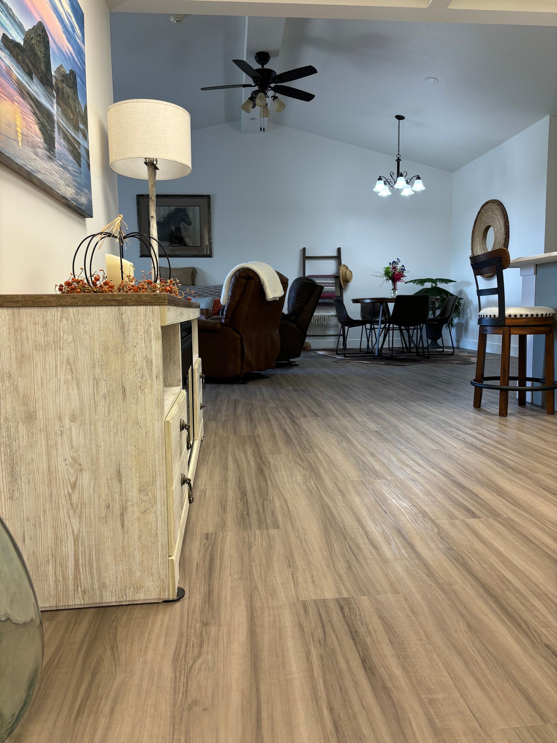 A living room with hardwood floors and a ceiling fan