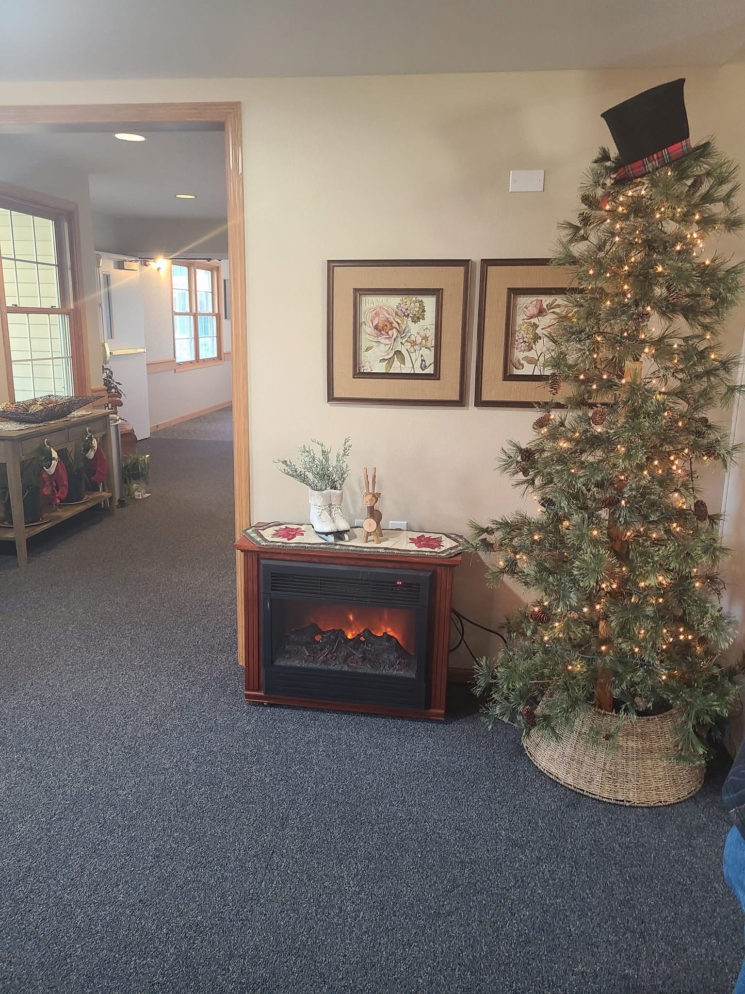 A living room with a fireplace and a christmas tree