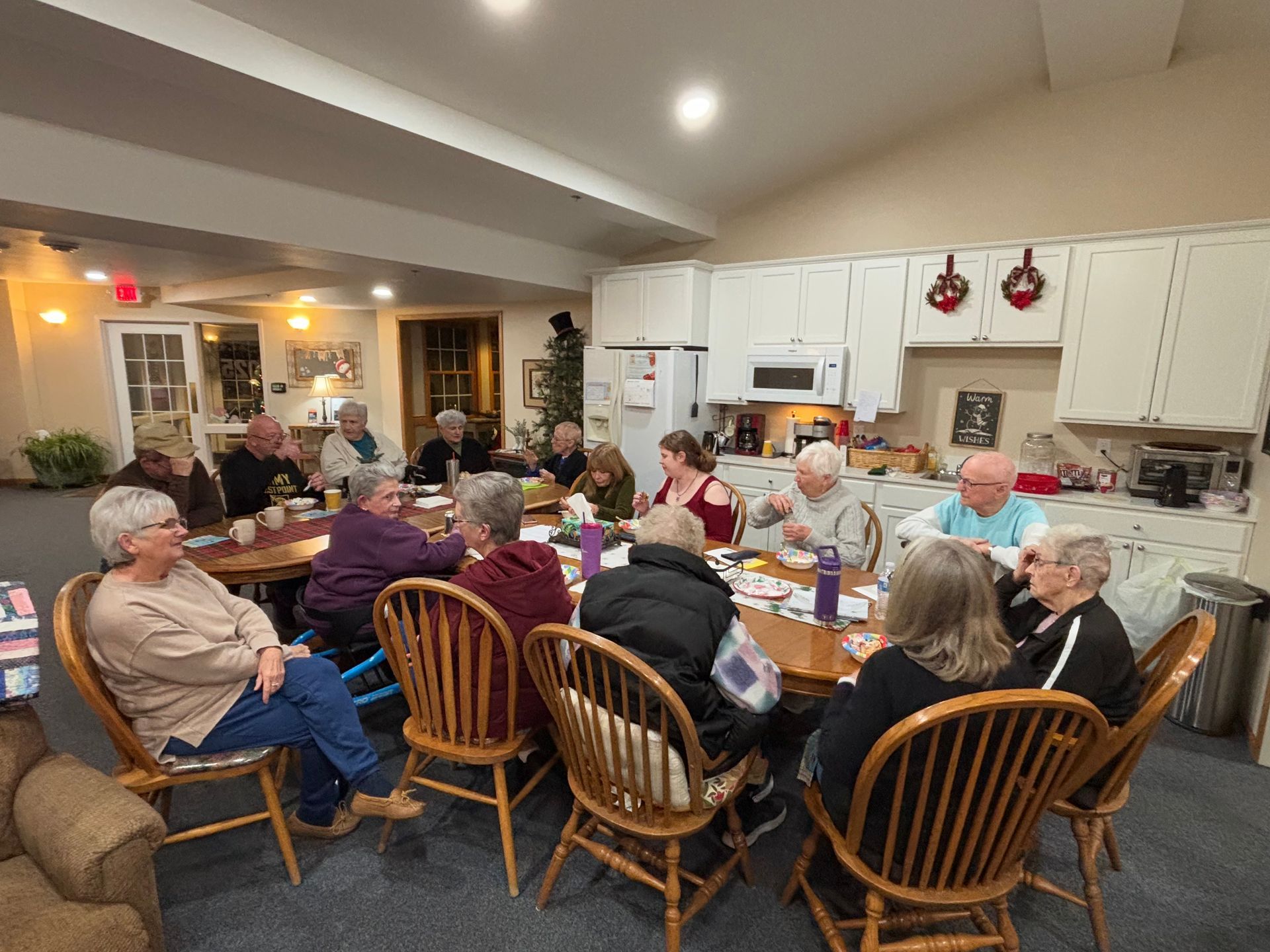 A group of people are sitting around a table in a room.