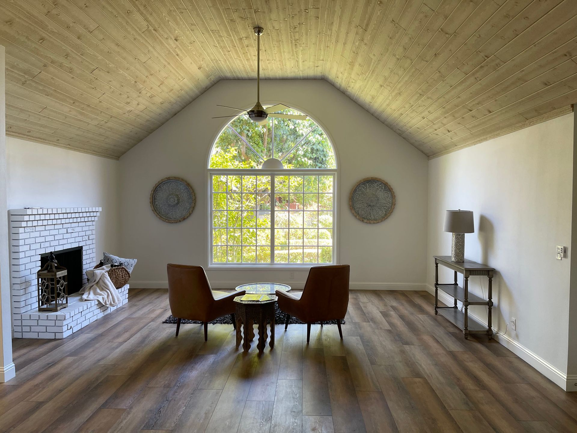 A living room with a fireplace and a large window