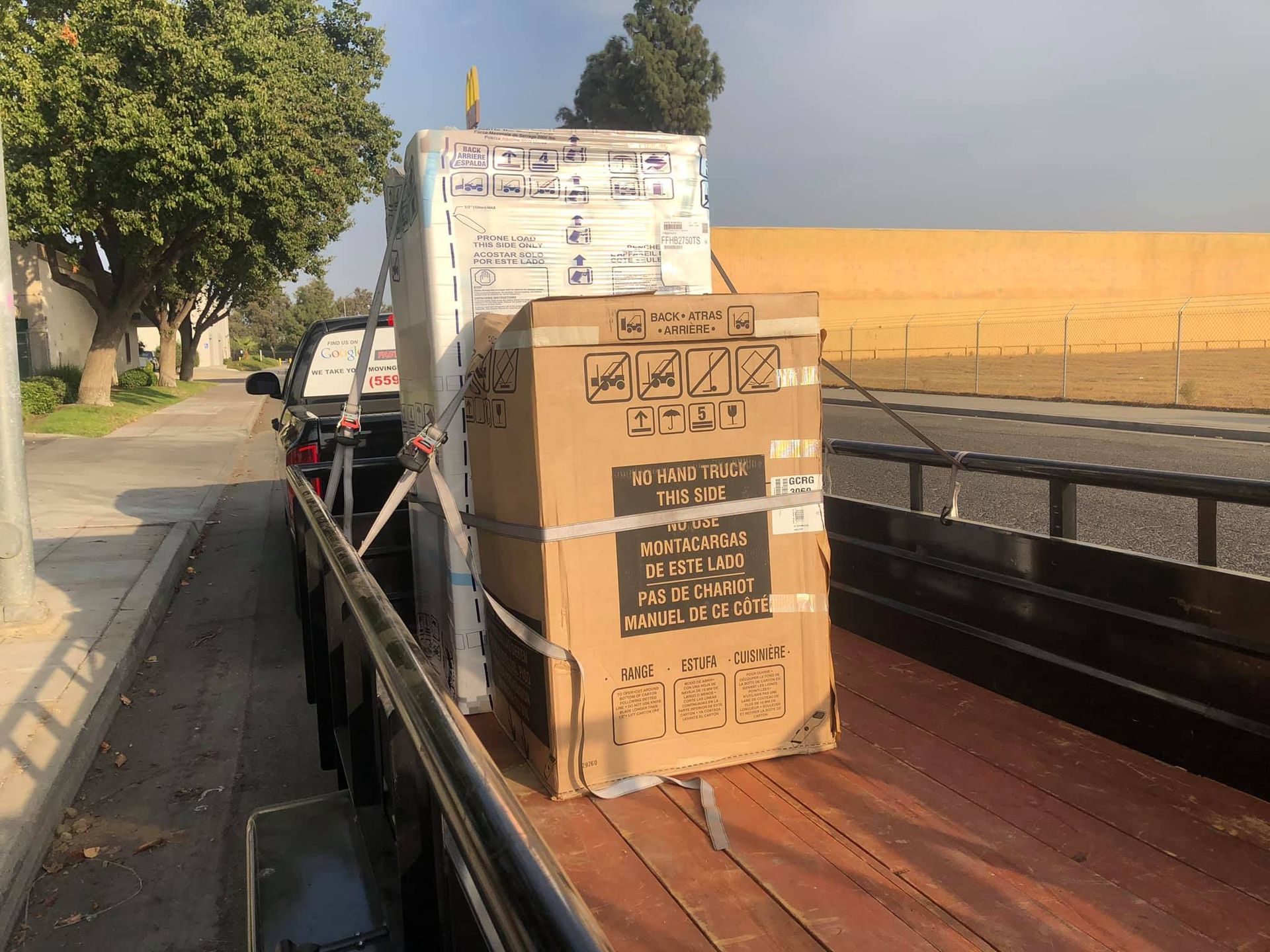 A cardboard box is sitting on the back of a truck.