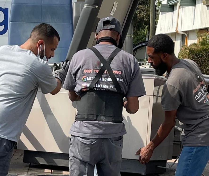 A group of men are working on a piece of equipment.