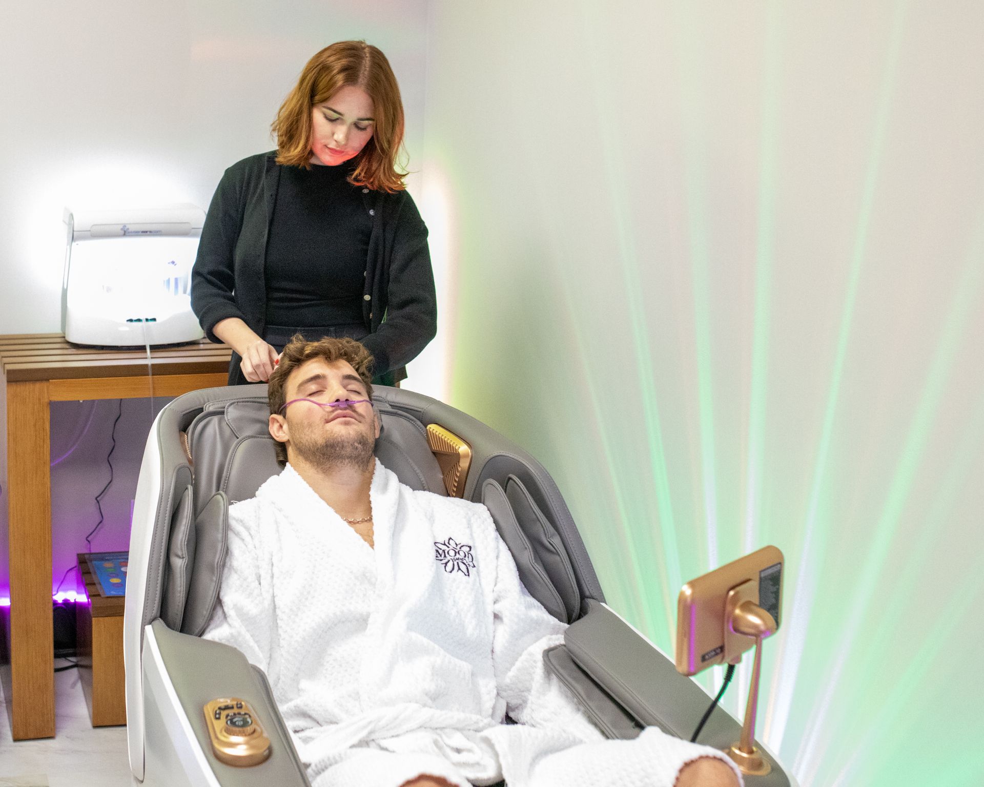 Woman in white robe, smelling laundry from the washing machine.