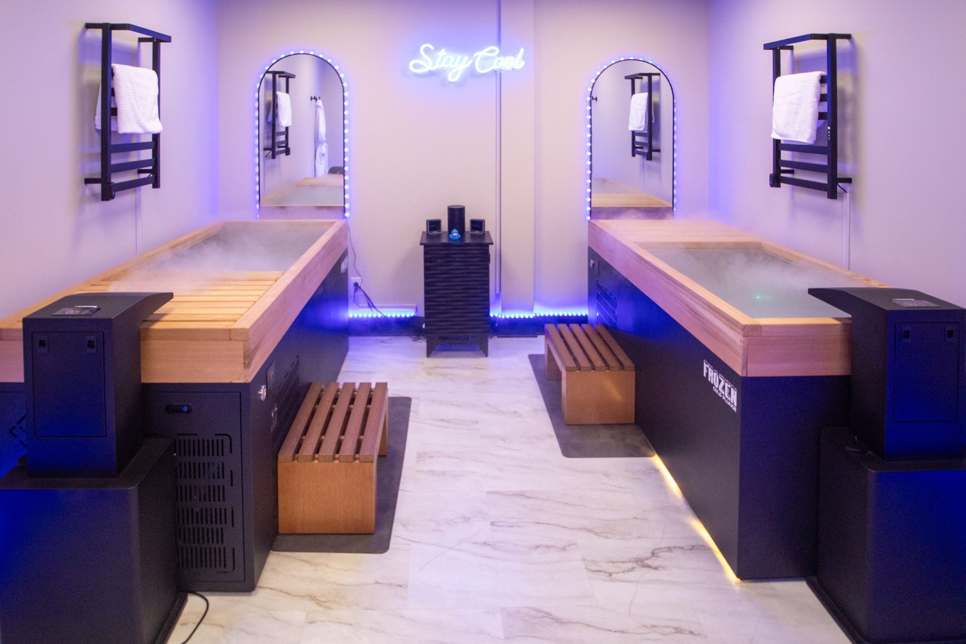 Woman in green swimsuit smiling in outdoor pool with snow.