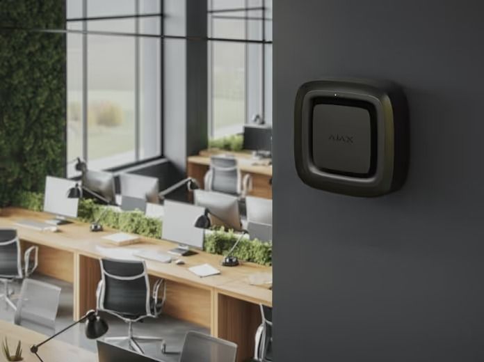 Black Air Purifier on a Dark Gray Wall in an Office Setting With Desks and a Green Wall — Cussler NQ in Cannonvale, QLD