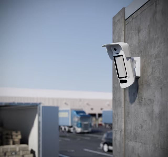 White Security Camera Mounted on Concrete Wall, Overlooking a Loading Dock — Cussler NQ in Cannonvale, QLD