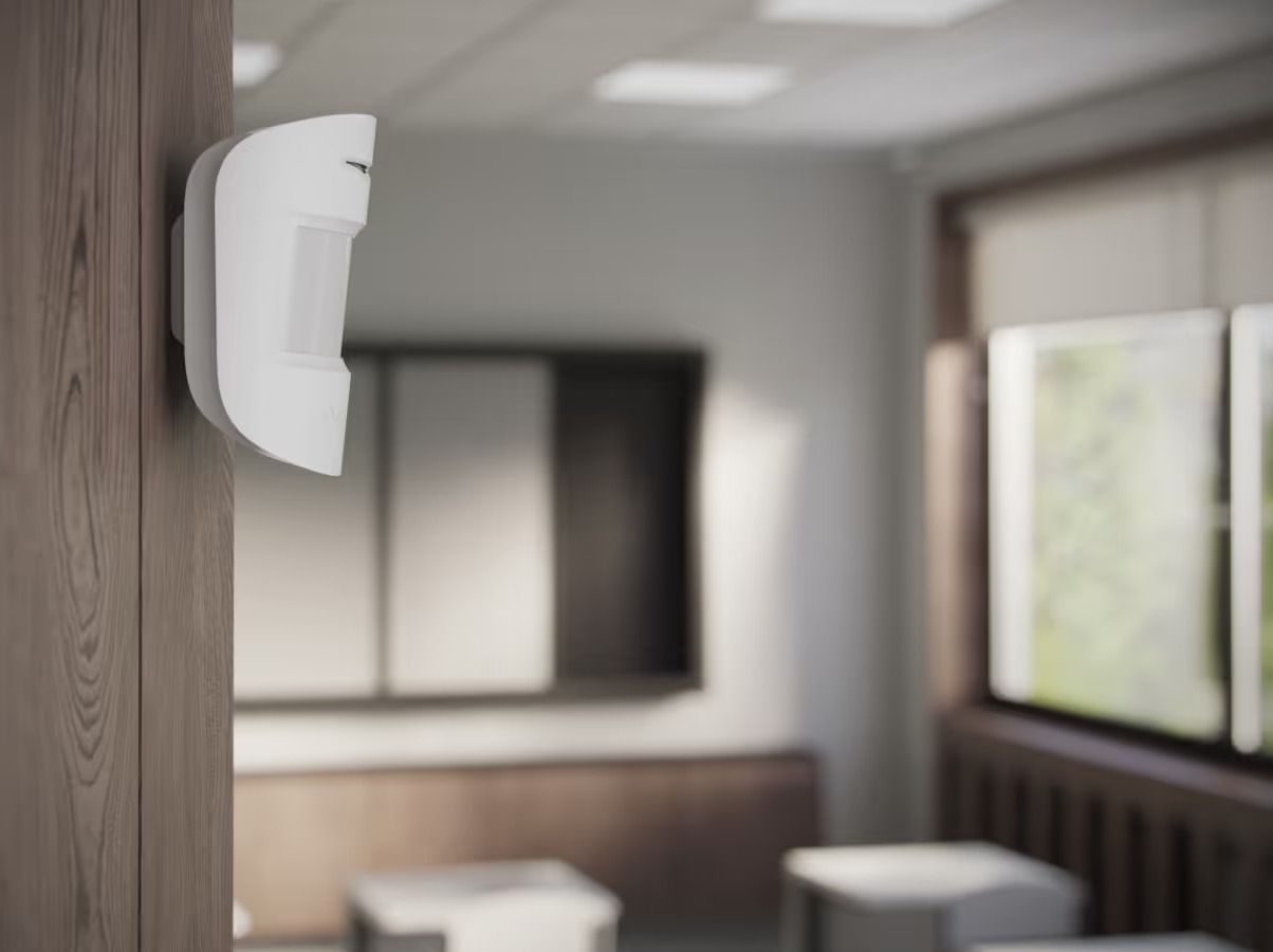 White Motion Sensor Mounted on a Wood Wall in a Room — Cussler NQ in Mackay, QLD