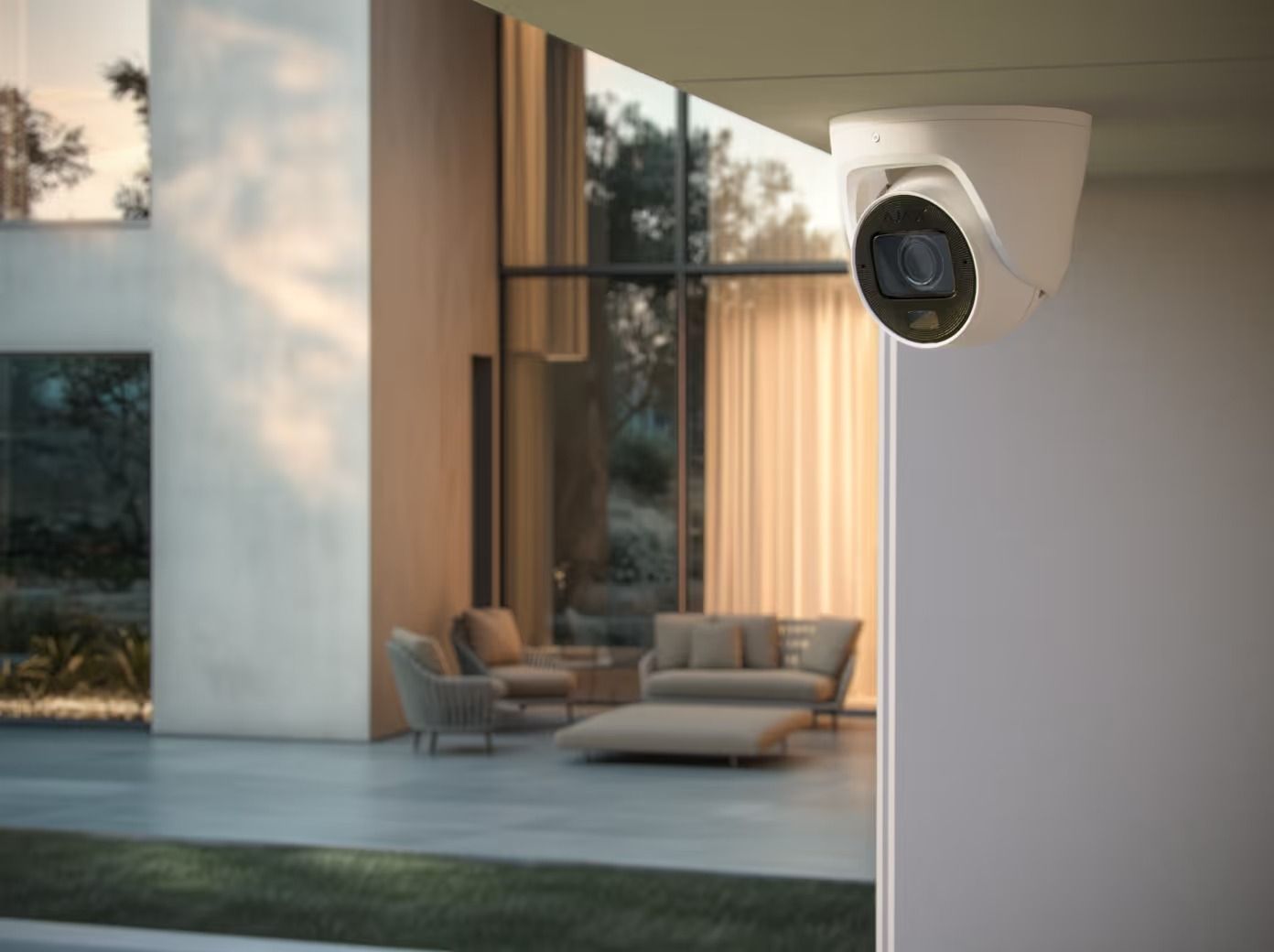 Security Camera Mounted on a Modern House Exterior, Overlooking a Living Room With Furniture — Cussler NQ in Cannonvale, QLD