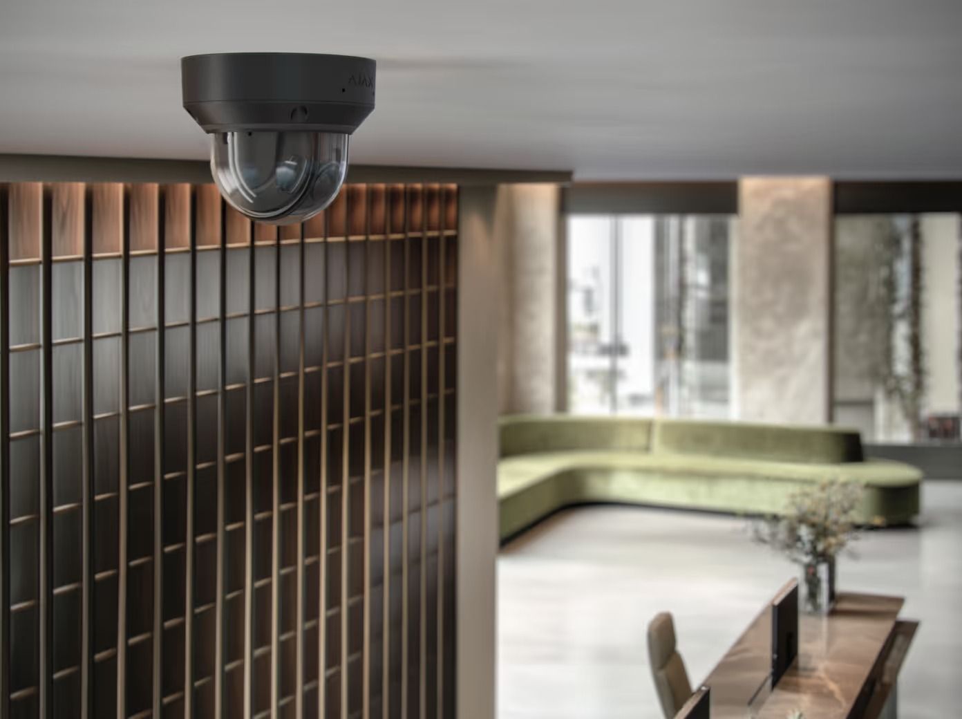 Security Camera Mounted on a Ceiling, Overlooking a Modern Lobby With a Green Sofa — Cussler NQ in Proserpine, QLD